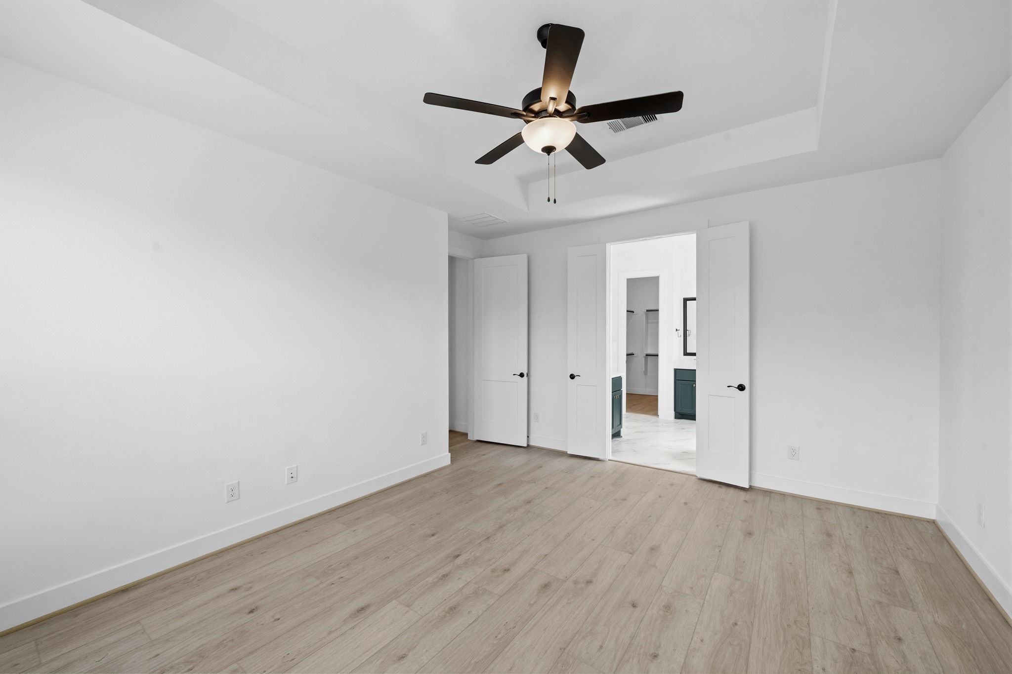 18103 Scarlett Hummingbird Court Conroe, TX 77302 - Photo 15 of 43 a view of a room with wooden floor and ceiling fan