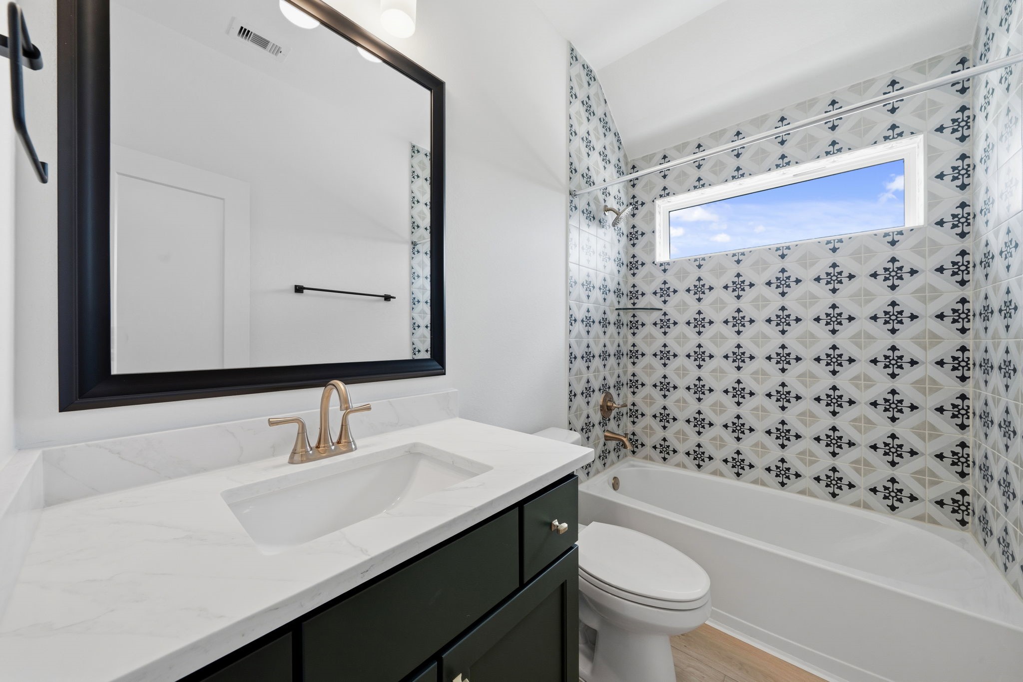 18103 Scarlett Hummingbird Court Conroe, TX 77302 - Photo 22 of 43 a bathroom with a sink a toilet and shower curtain