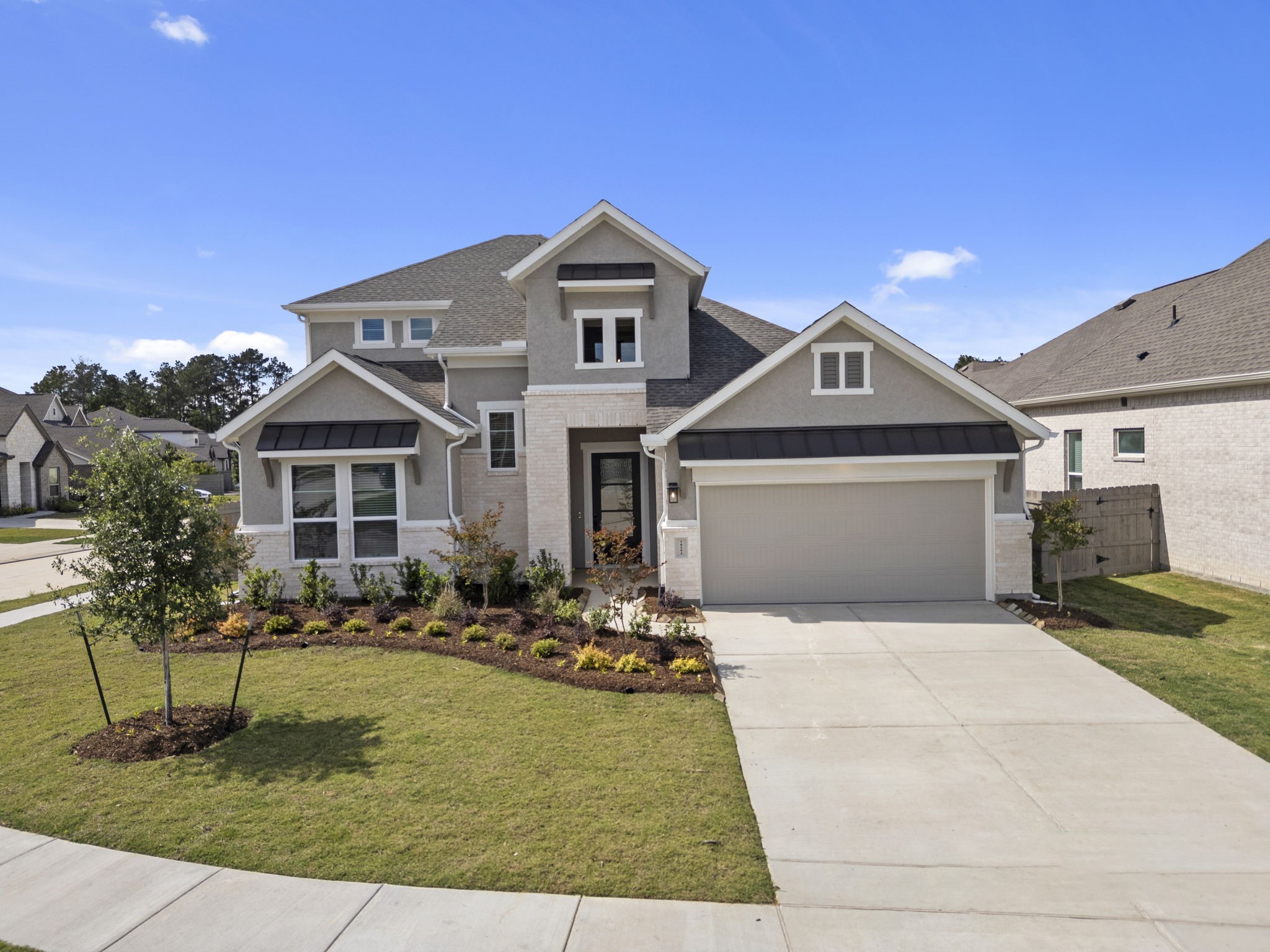 18103 Scarlett Hummingbird Court Conroe, TX 77302 - Photo 29 of 43 a front view of a house with a yard