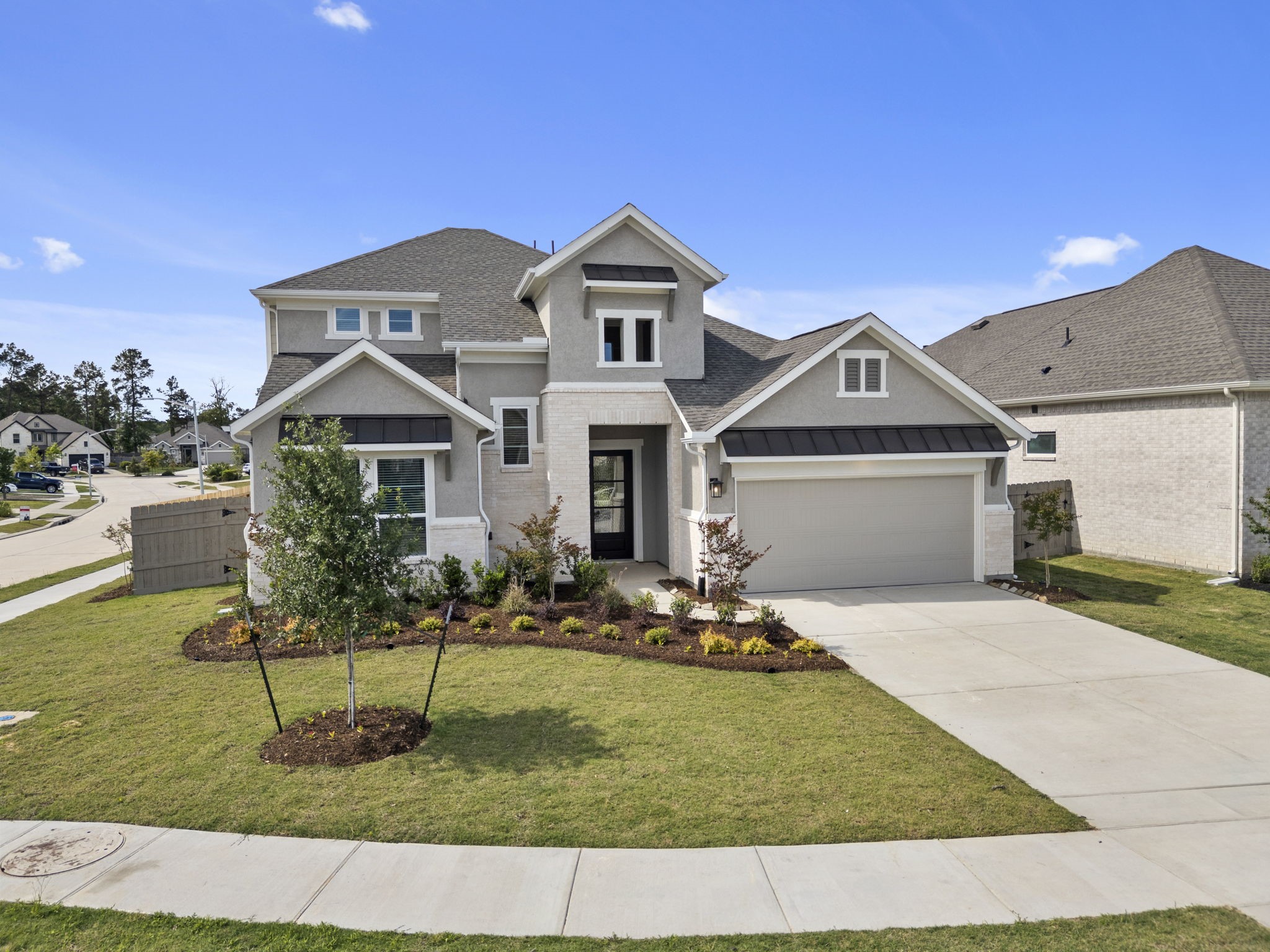 18103 Scarlett Hummingbird Court Conroe, TX 77302 - Photo 31 of 43 a front view of a house with a yard