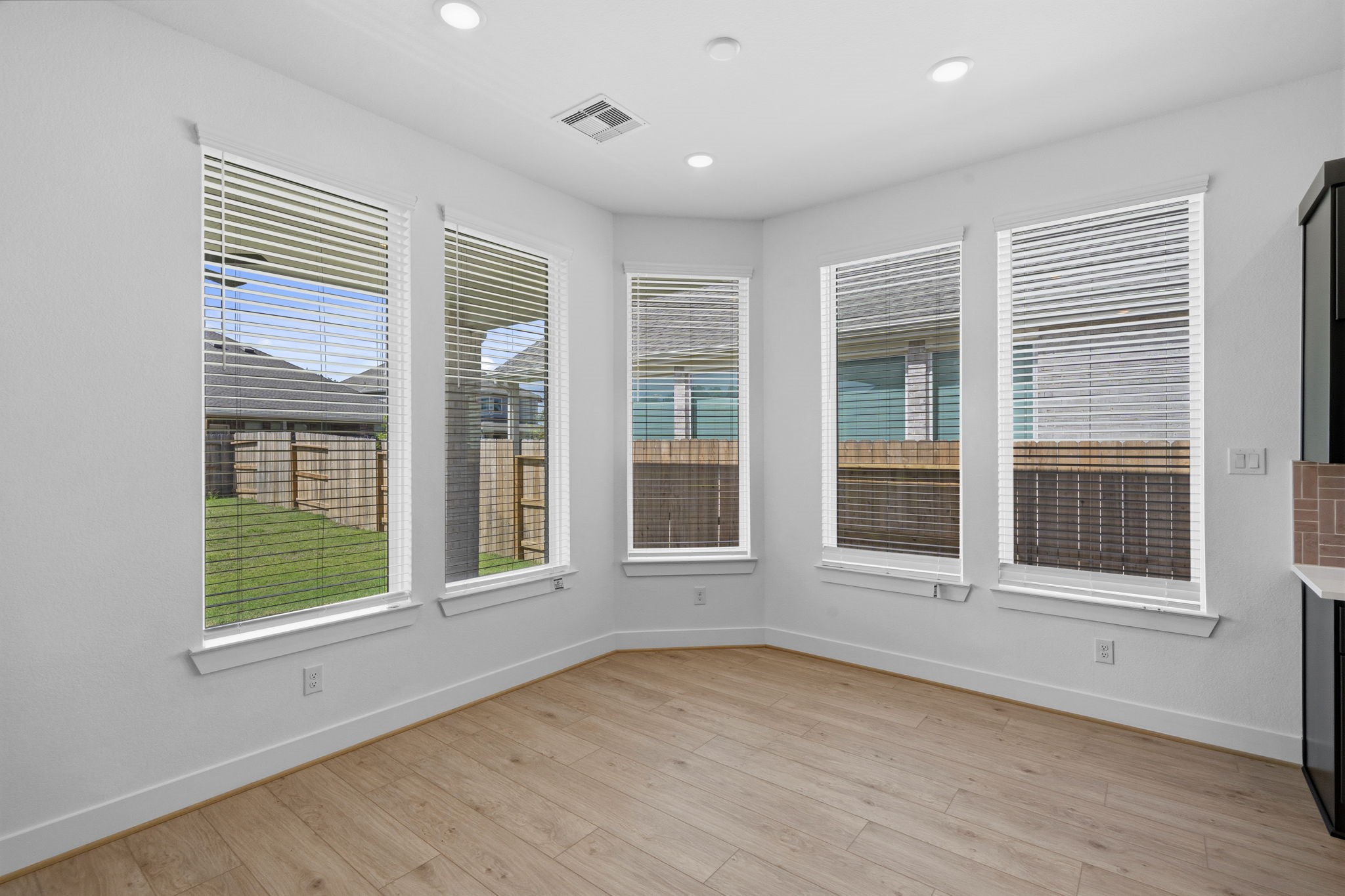18103 Scarlett Hummingbird Court Conroe, TX 77302 - Photo 10 of 43 a view of an empty room with a window and wooden floor