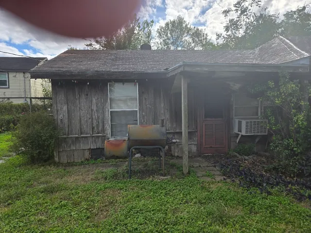 a view of a patio with table and chairs and wooden fence