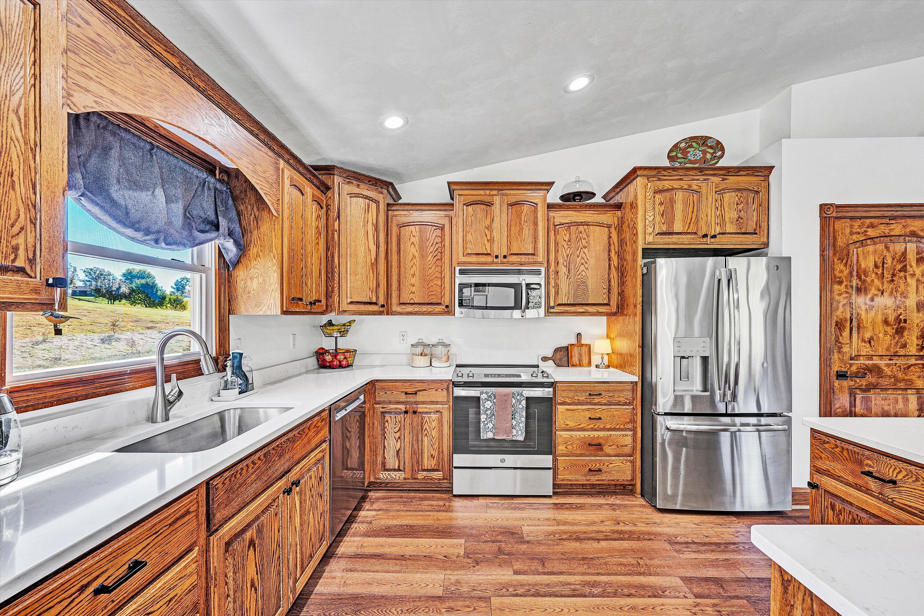 99 Spruce Lane Callaway, VA 24067 - Photo 2 of 19 a kitchen with stainless steel appliances granite countertop a refrigerator a stove a sink and a wooden cabinets