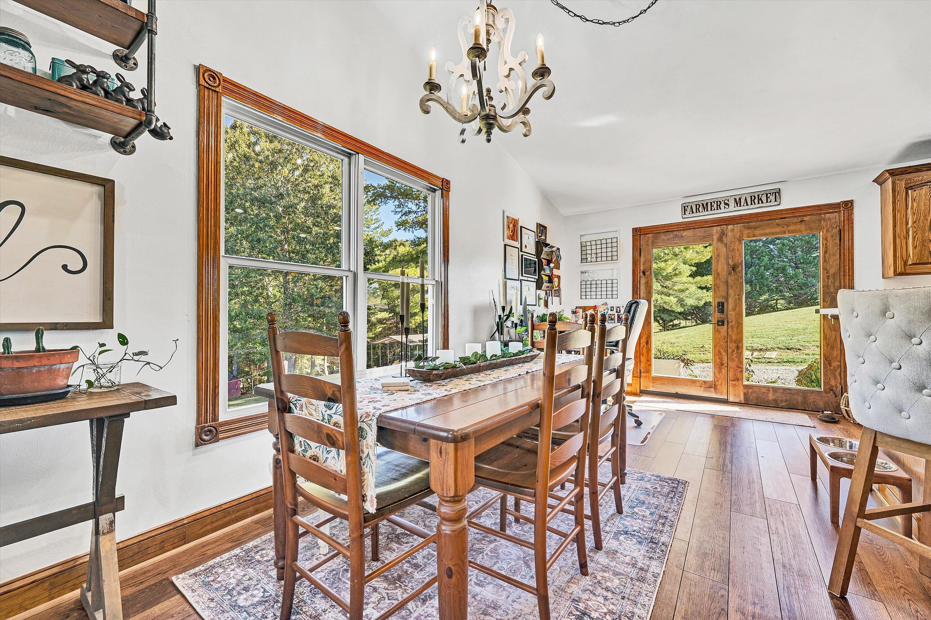 99 Spruce Lane Callaway, VA 24067 - Photo 5 of 19 a view of a dining room with furniture large window and wooden floor