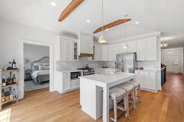 a kitchen with white cabinets and stainless steel appliances