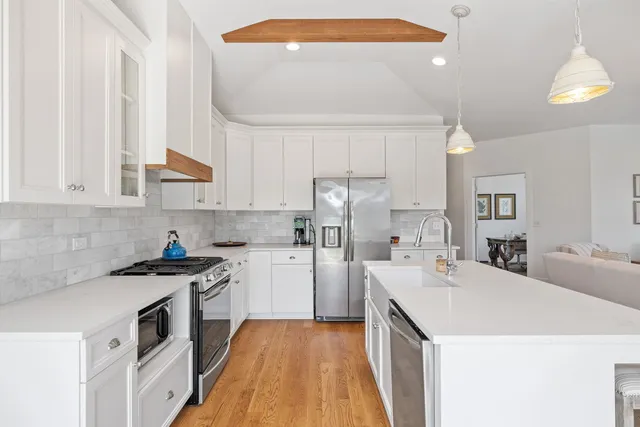 a kitchen with a sink a stove and cabinets