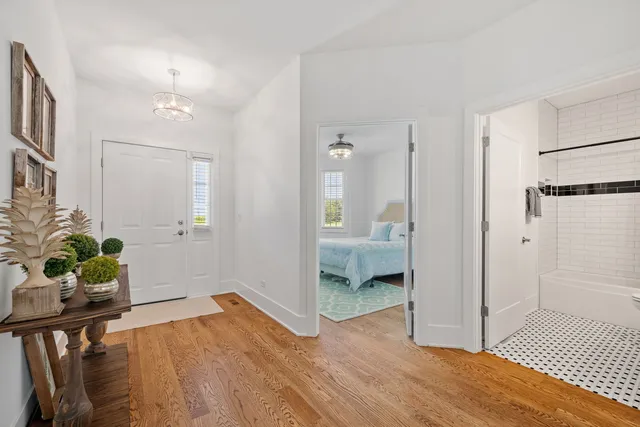 a view of a room with wooden floor and a bathroom
