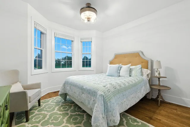 a bedroom with a bed and chair