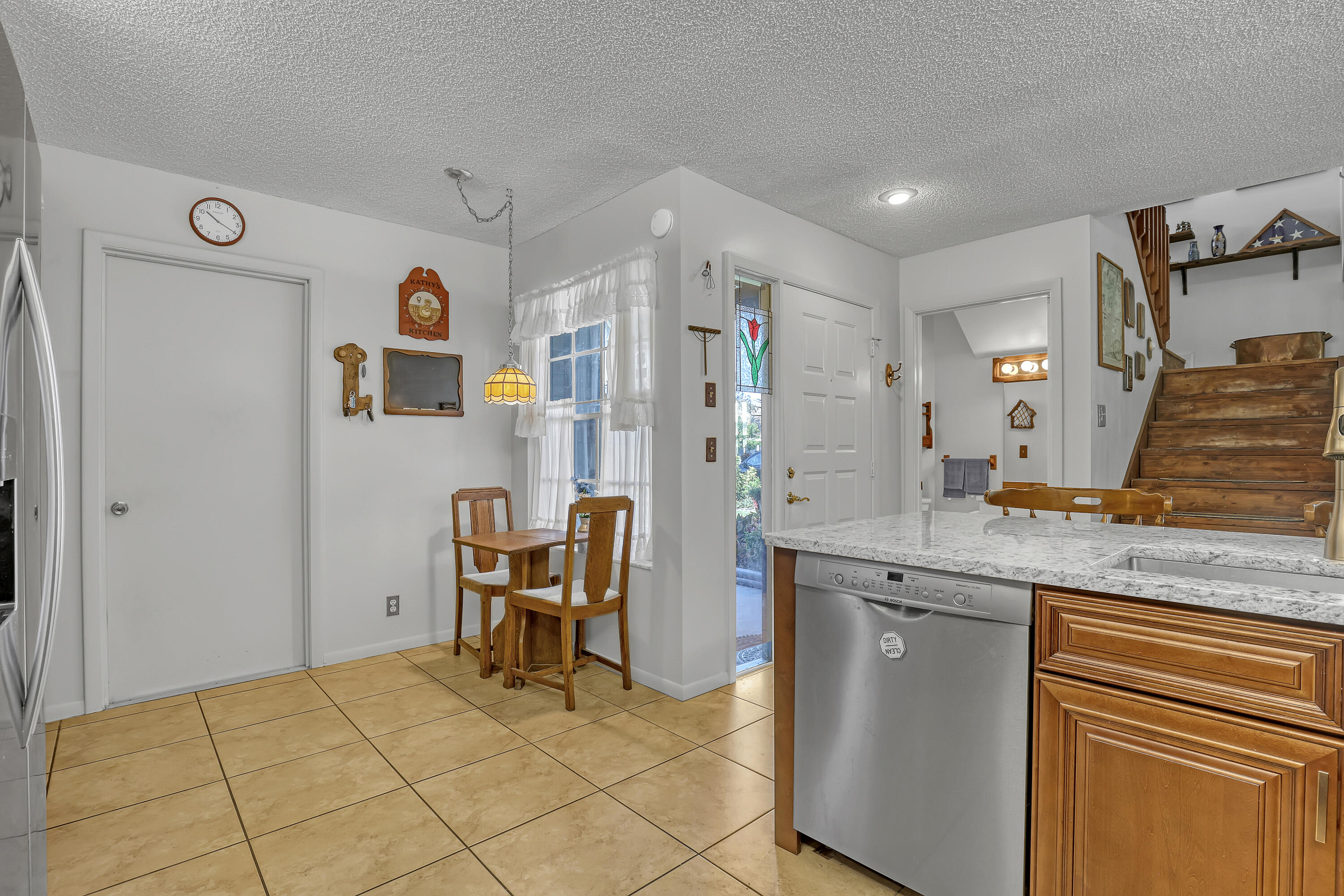13116 Quiet Woods Road, Unit A Wellington, FL 33414 - Photo 14 of 31 a kitchen with stainless steel appliances granite countertop a sink and cabinets