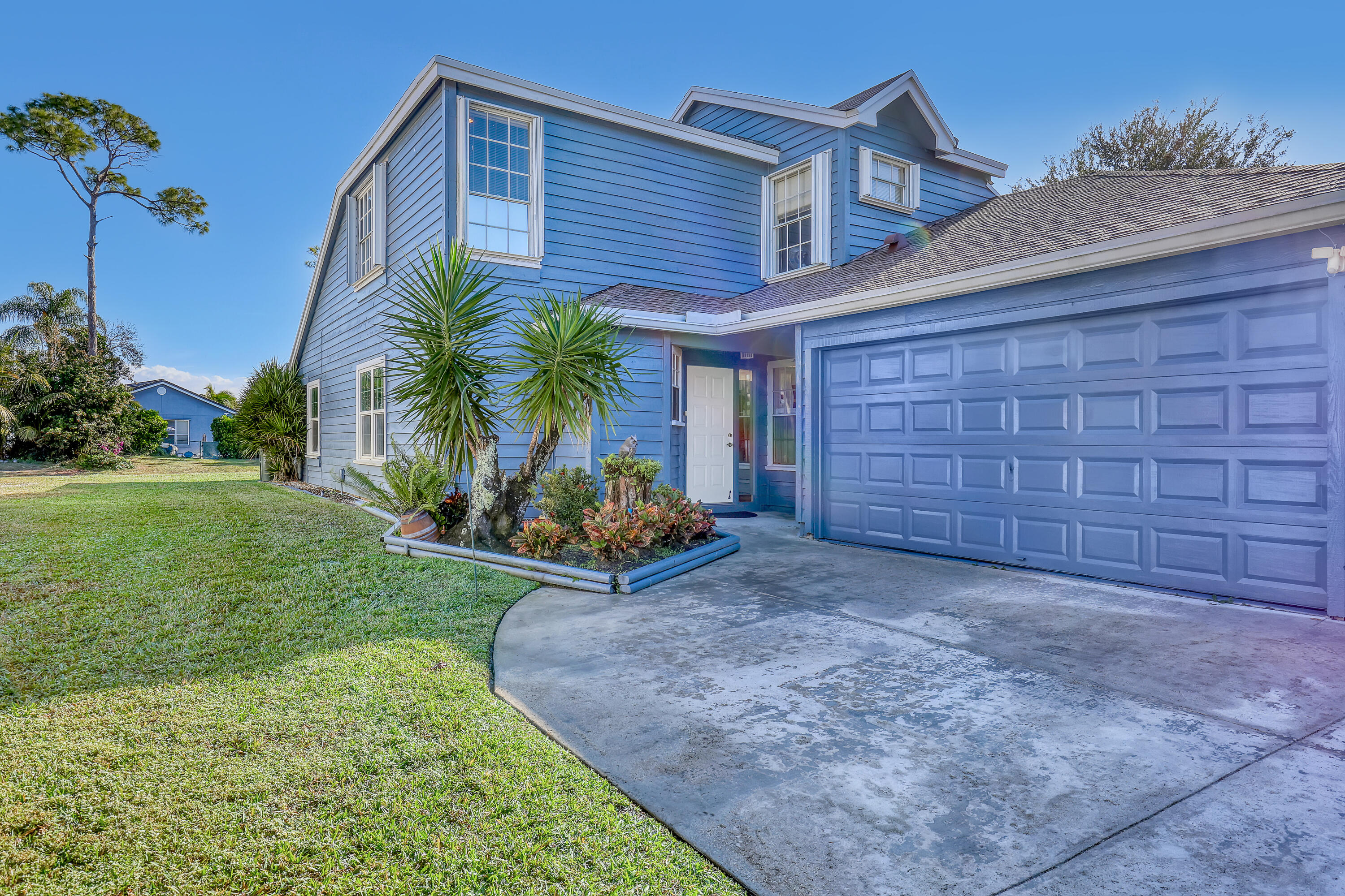 13116 Quiet Woods Road, Unit A Wellington, FL 33414 - Photo 2 of 31 a view of a backyard with plants and a large tree