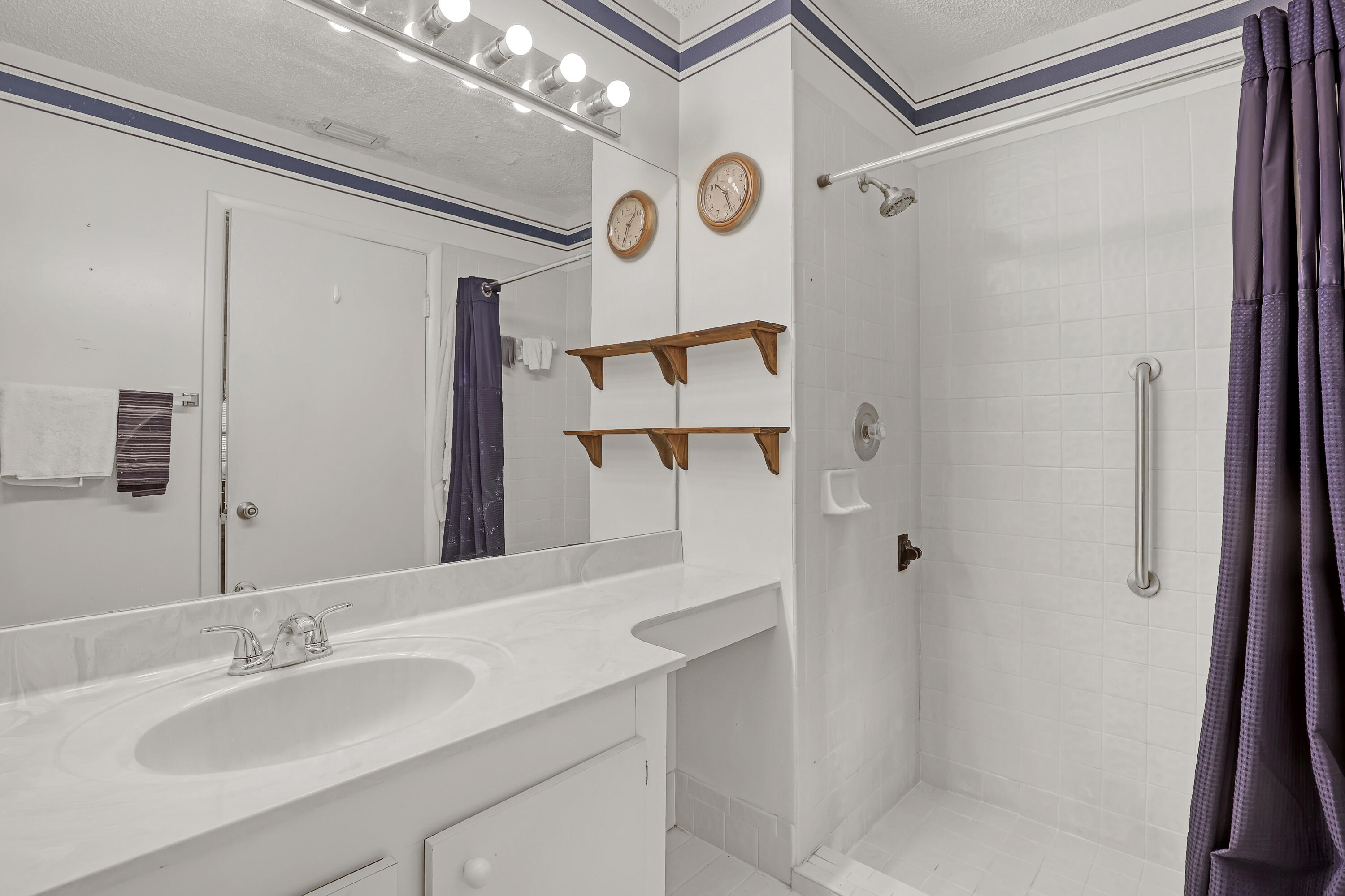 13116 Quiet Woods Road, Unit A Wellington, FL 33414 - Photo 22 of 31 a bathroom with a sink and a mirror