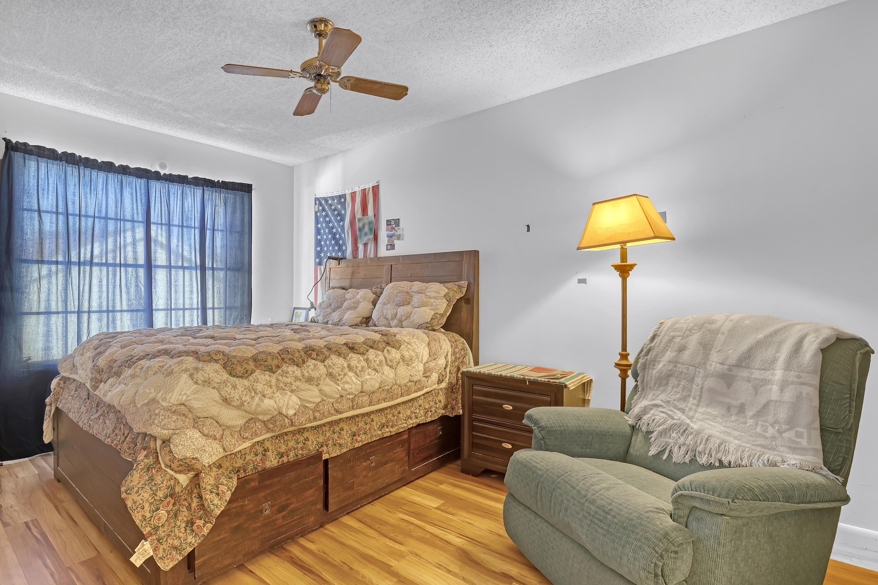 13116 Quiet Woods Road, Unit A Wellington, FL 33414 - Photo 24 of 31 a bedroom with a bed couch and window