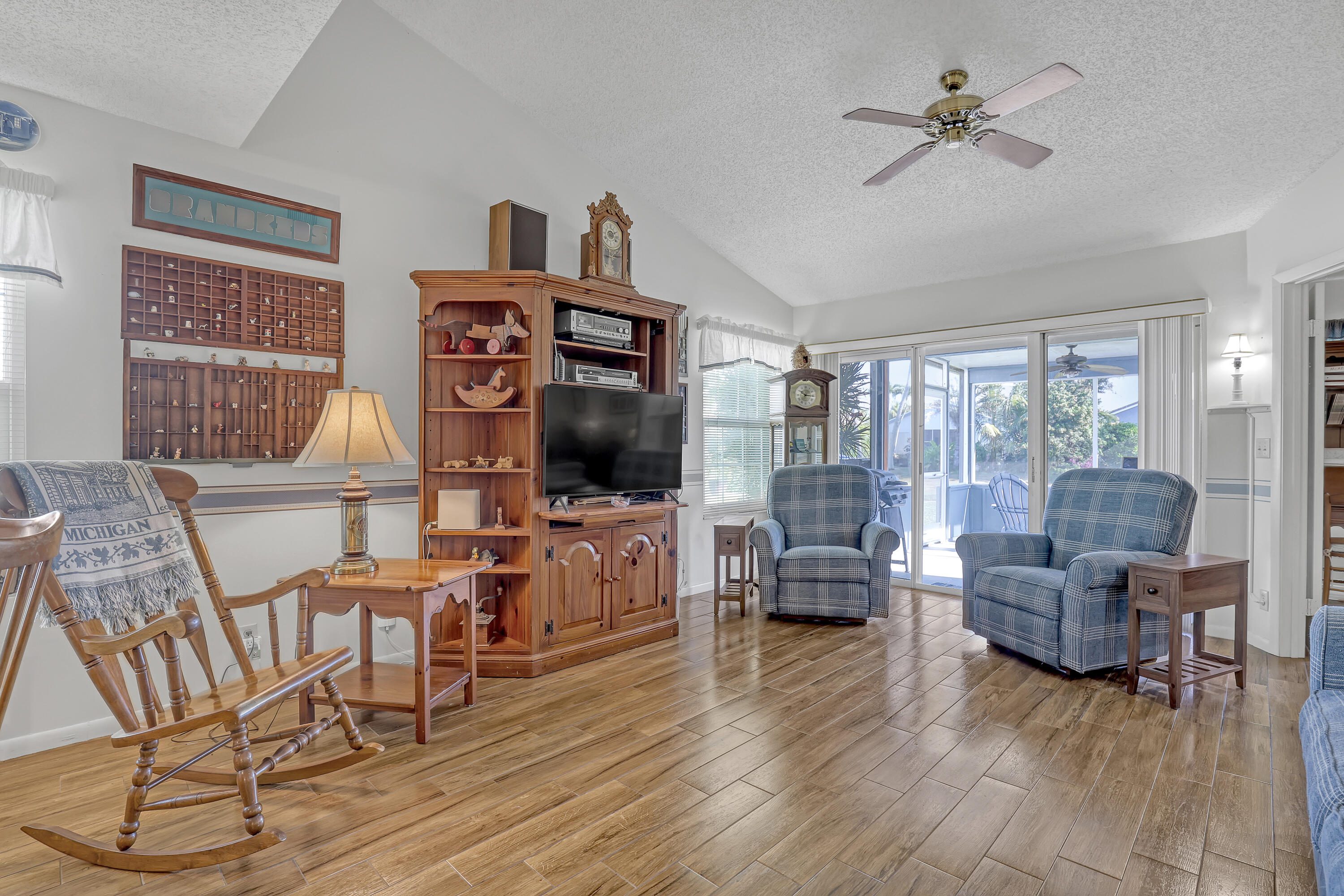 13116 Quiet Woods Road, Unit A Wellington, FL 33414 - Photo 7 of 31 a living room with furniture and a flat screen tv