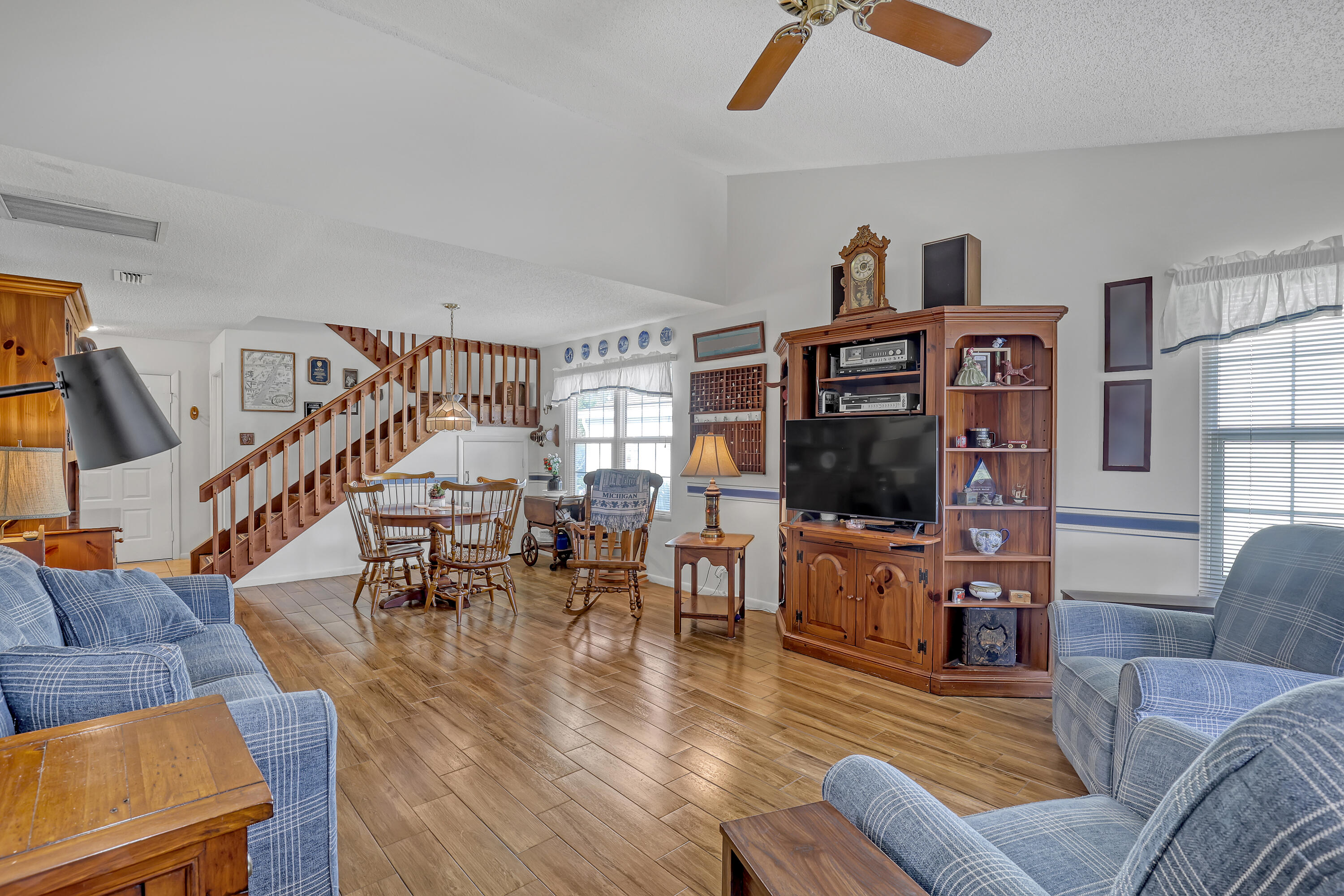 13116 Quiet Woods Road, Unit A Wellington, FL 33414 - Photo 8 of 31 a living room with furniture flat screen tv and wooden floor