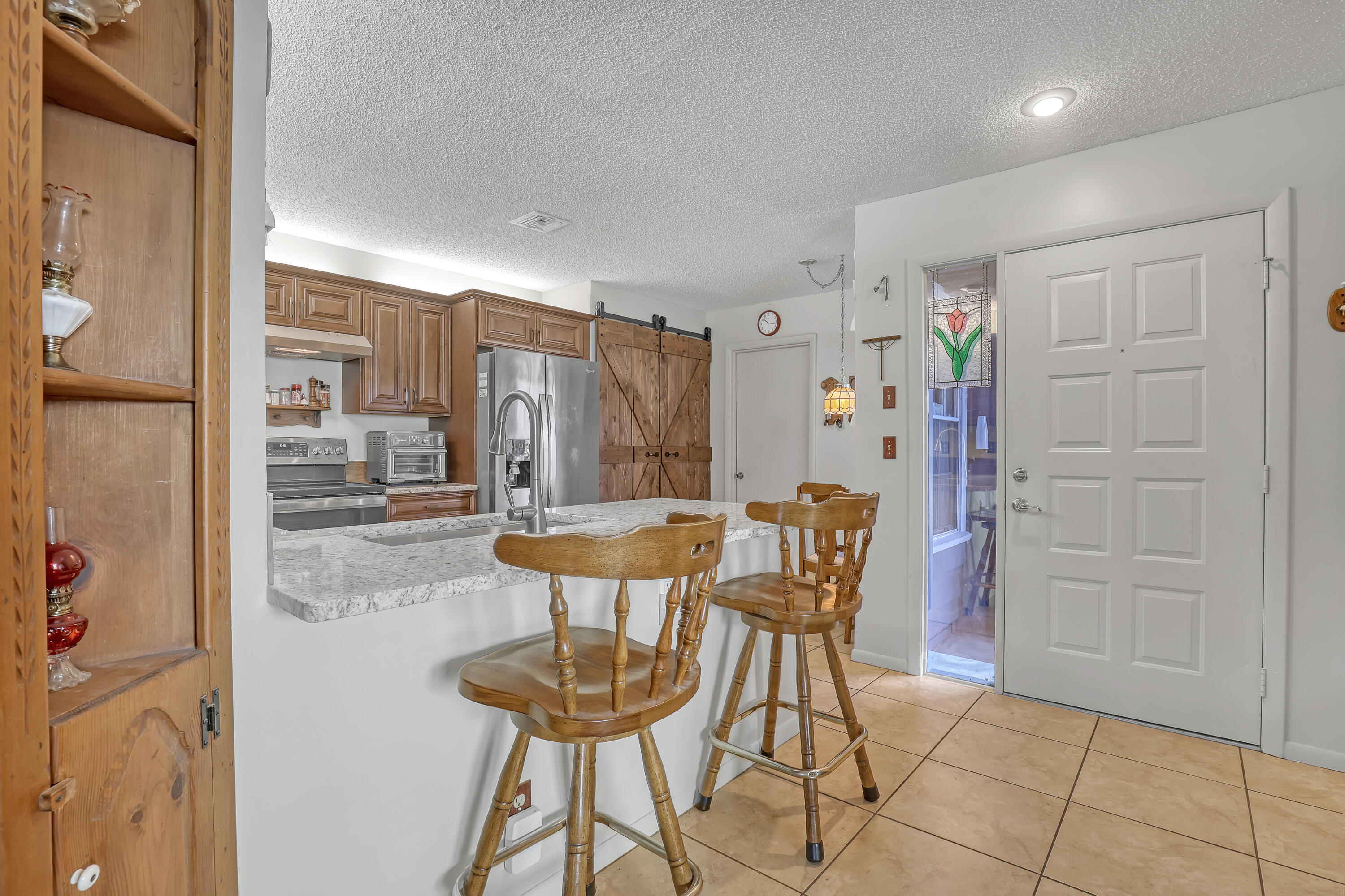 13116 Quiet Woods Road, Unit A Wellington, FL 33414 - Photo 10 of 31 a view of a dining room with furniture