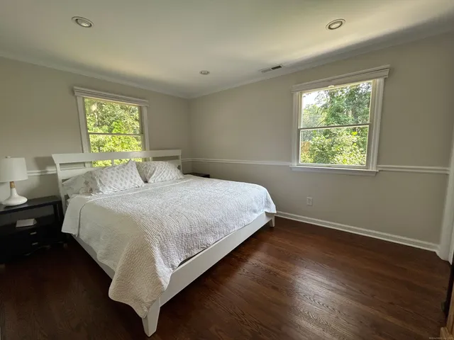 a bedroom with a bed and window