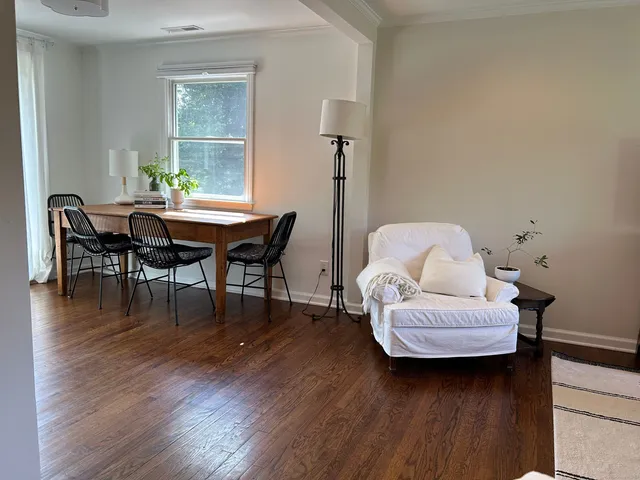 a living room with furniture and wooden floor