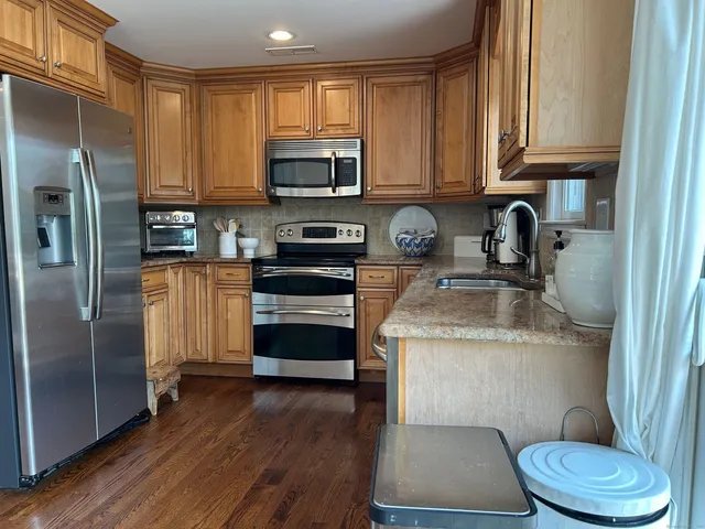 a kitchen with a sink a stove and refrigerator