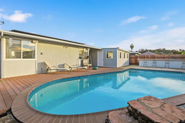 a view of a swimming pool with an outdoor seating