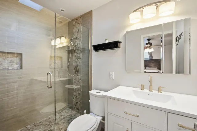 a bathroom with a sink toilet and shower