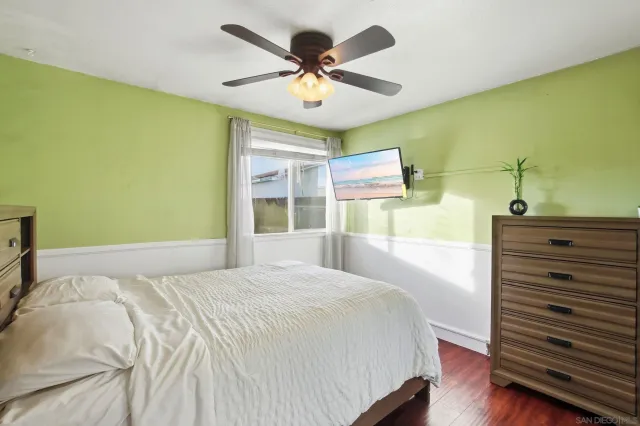 a bedroom with a bed and a ceiling fan