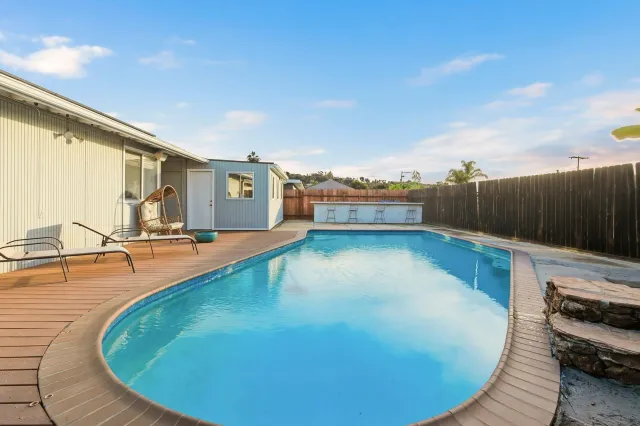 a view of a swimming pool with an outdoor seating