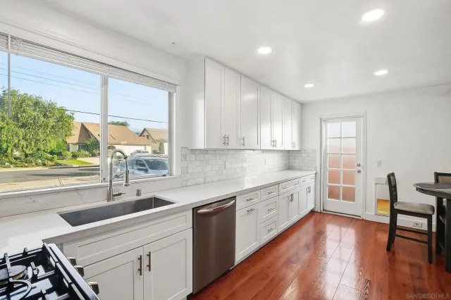 a kitchen with sink cabinets and wooden floor