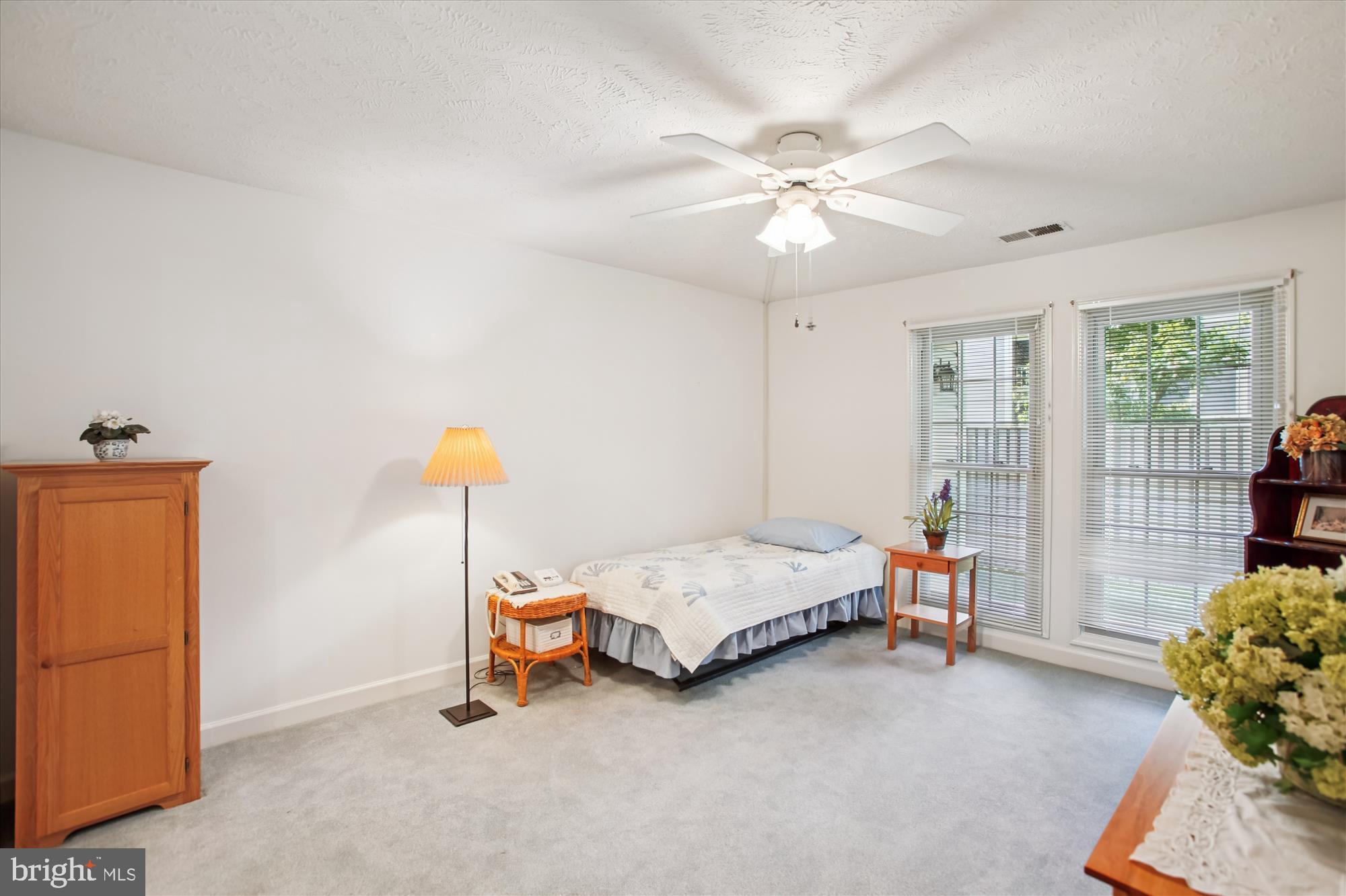 3800 Ridge Knoll Court, Unit 2 Fairfax, VA 22033 - Photo 17 of 50 a bedroom with a bed and a chandelier