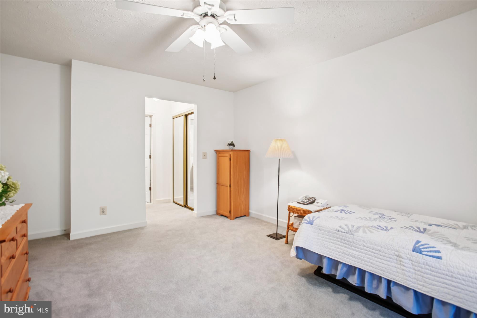 3800 Ridge Knoll Court, Unit 2 Fairfax, VA 22033 - Photo 18 of 50 a bedroom with a bed and a chandelier