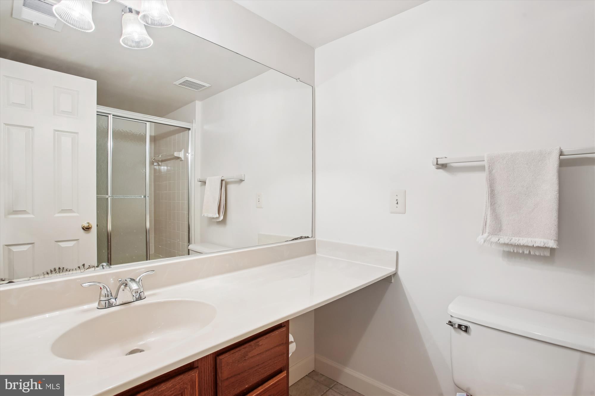 3800 Ridge Knoll Court, Unit 2 Fairfax, VA 22033 - Photo 20 of 50 a bathroom with a sink a toilet and a mirror