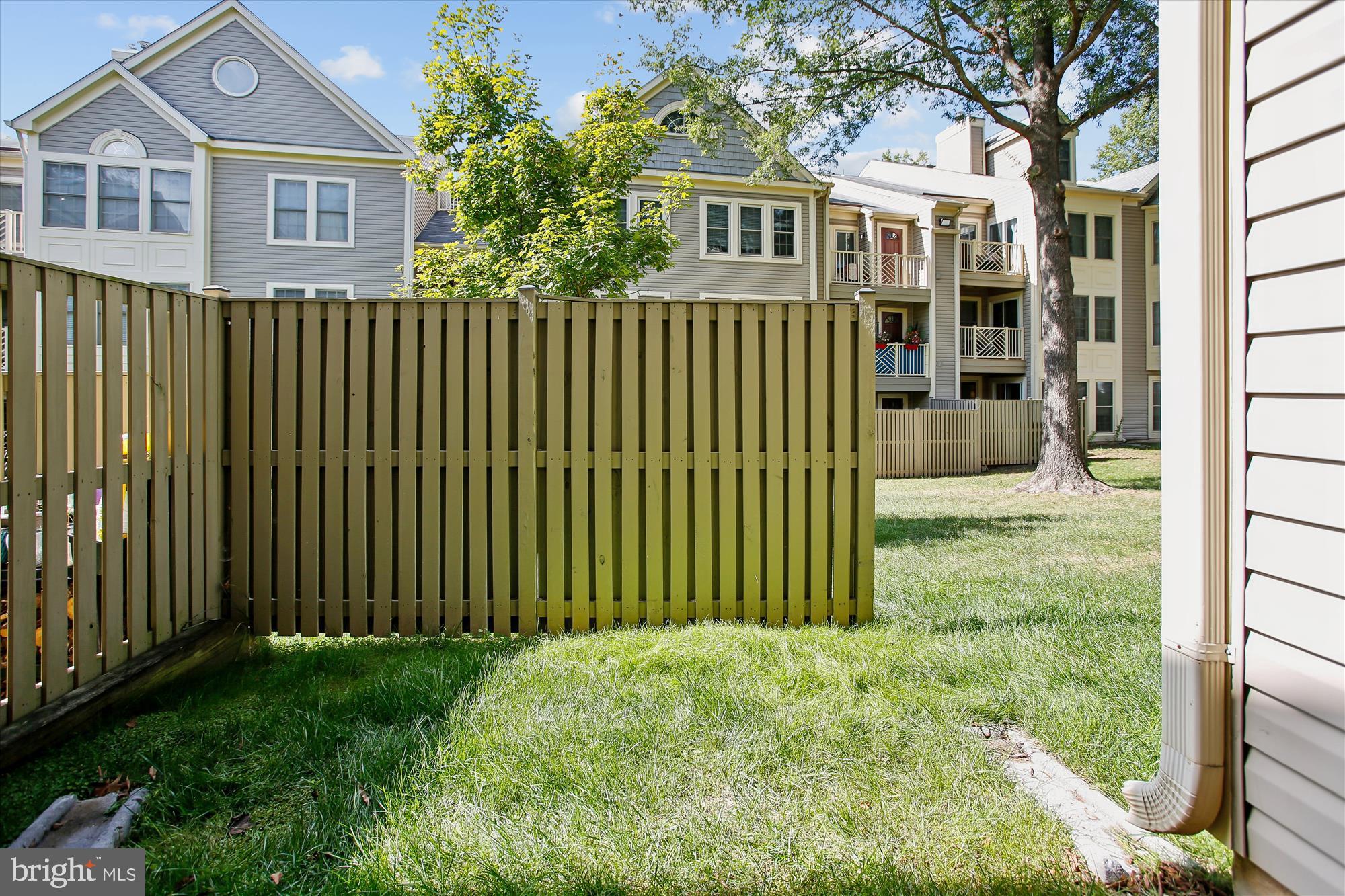 3800 Ridge Knoll Court, Unit 2 Fairfax, VA 22033 - Photo 30 of 50 a view of a brick house with a yard and large trees