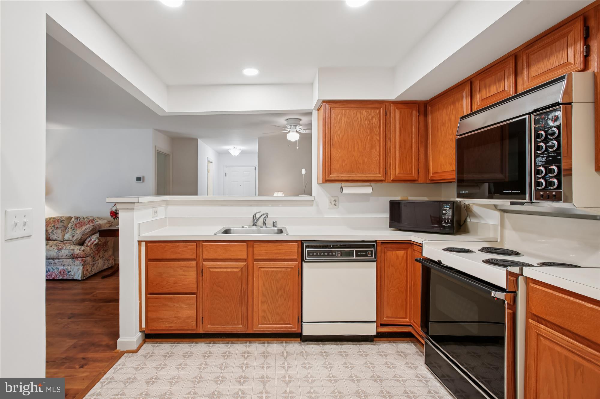 3800 Ridge Knoll Court, Unit 2 Fairfax, VA 22033 - Photo 6 of 50 a kitchen with stainless steel appliances a stove microwave and sink