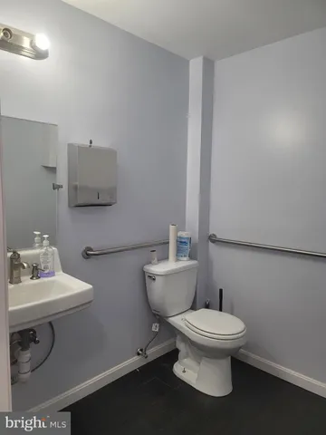 a white toilet sitting next to a bathroom sink