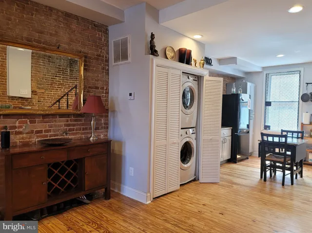 a view of kitchen and utility room with wooden floor