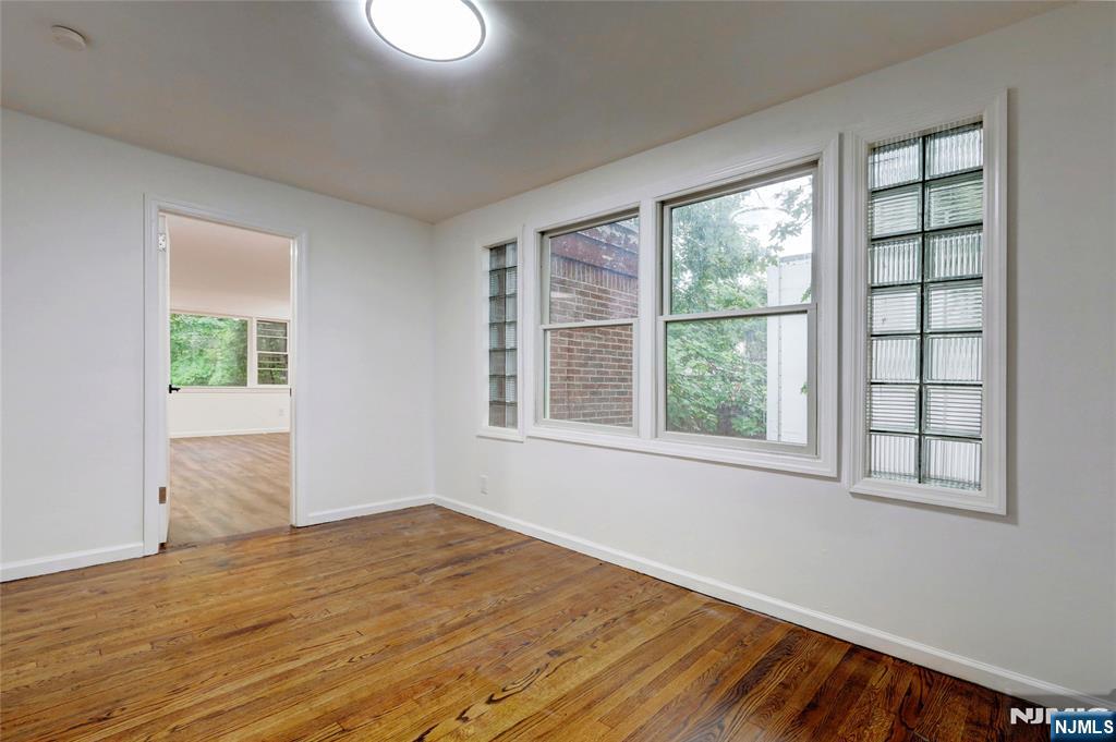 4-21 Saddle River Road, Unit 1 Fair Lawn, NJ 07410 - Photo 16 of 19 a view of empty room with wooden floor and fan