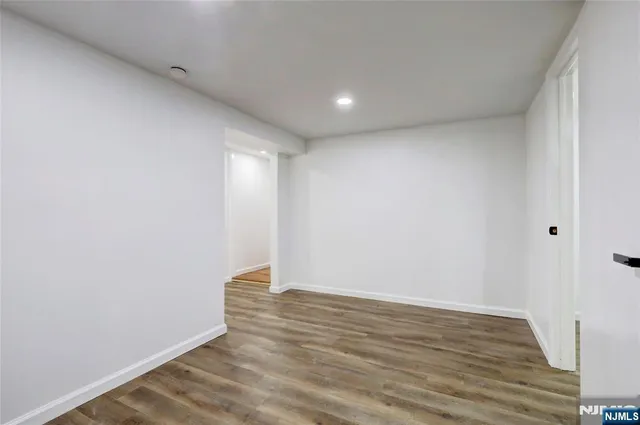 a view of room with wooden floor