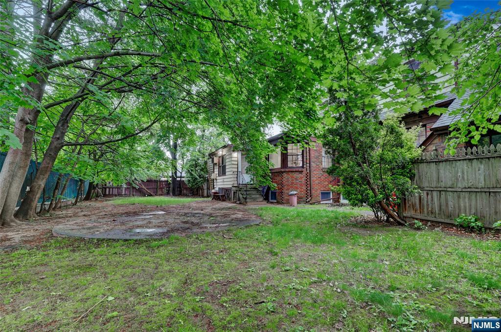 4-21 Saddle River Road, Unit 1 Fair Lawn, NJ 07410 - Photo 19 of 19 a view of a backyard with large trees and plants