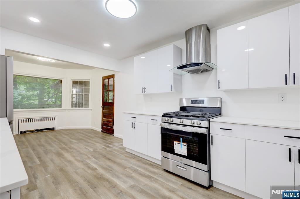 4-21 Saddle River Road, Unit 1 Fair Lawn, NJ 07410 - Photo 6 of 19 a kitchen with a stove and a sink