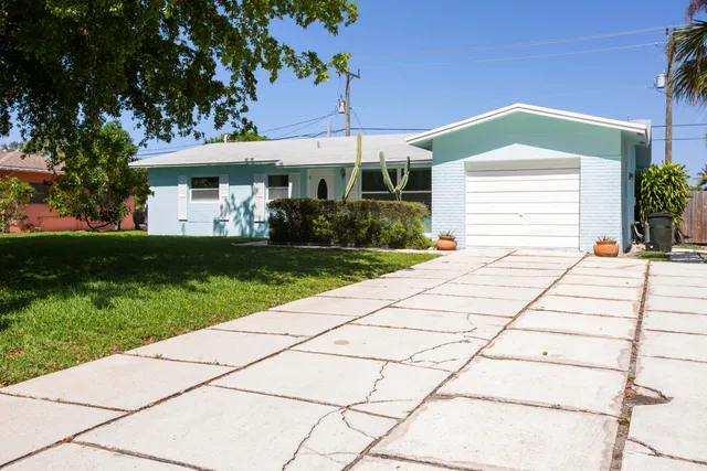 a patio with a table and chairs under an umbrella