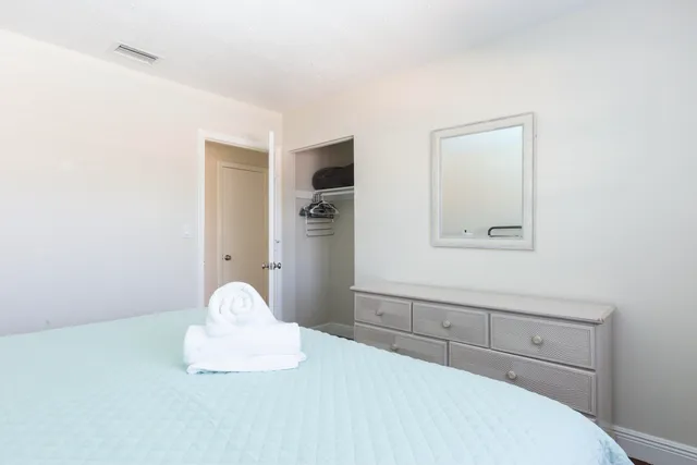 a bedroom with a bed and a dresser