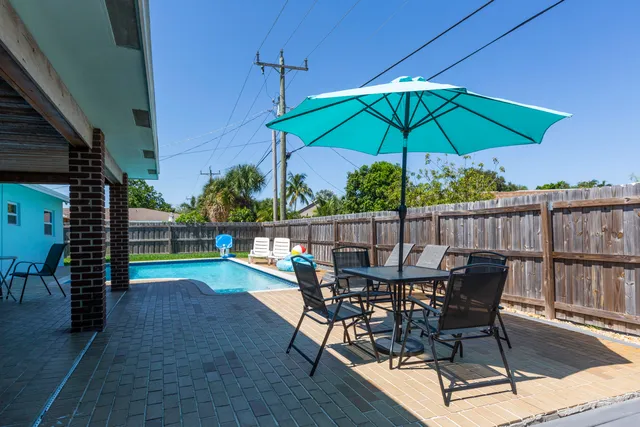 an outdoor space with furniture and umbrella