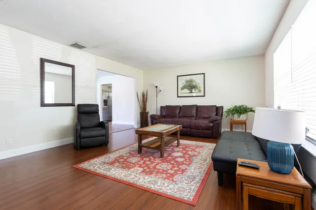 a living room with furniture rug and window