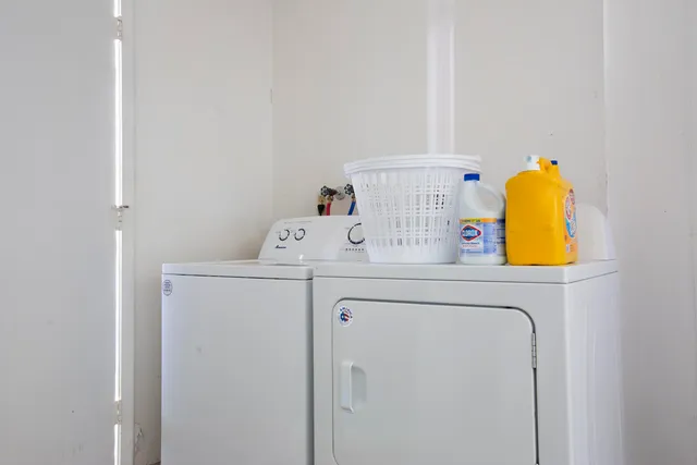 a utility room with a sink dryer and washer