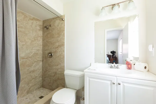 a bathroom with a sink toilet and shower