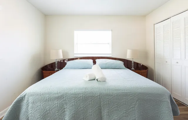 a bedroom with a bed and window