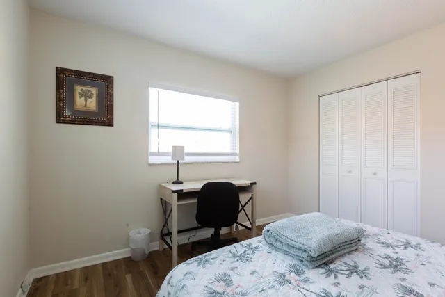 a bedroom with a bed and a window