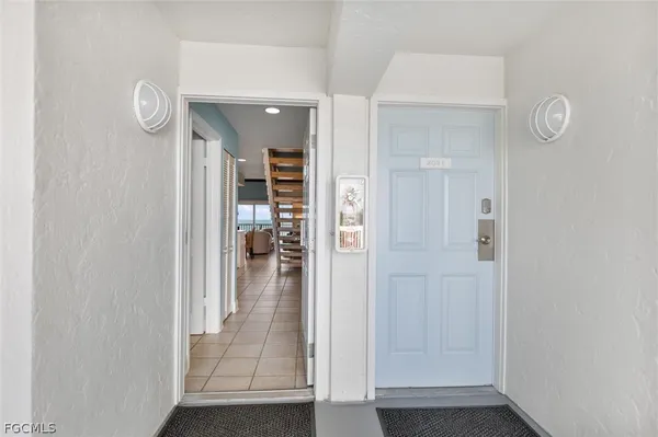 a view of a hallway with wooden floor