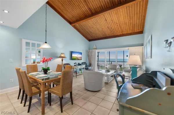 a dining room with furniture and a wooden floor