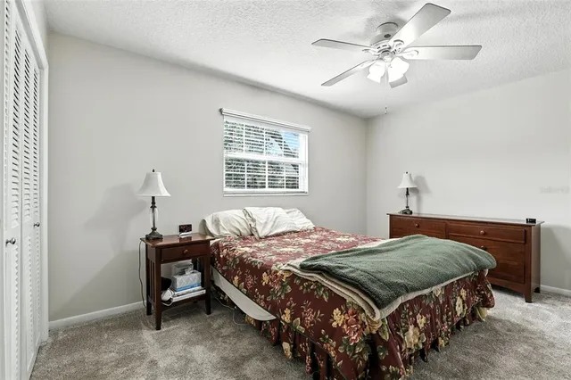 a bedroom with a bed a chandelier and a window