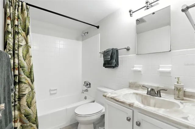 a bathroom with a sink a toilet and a bathtub